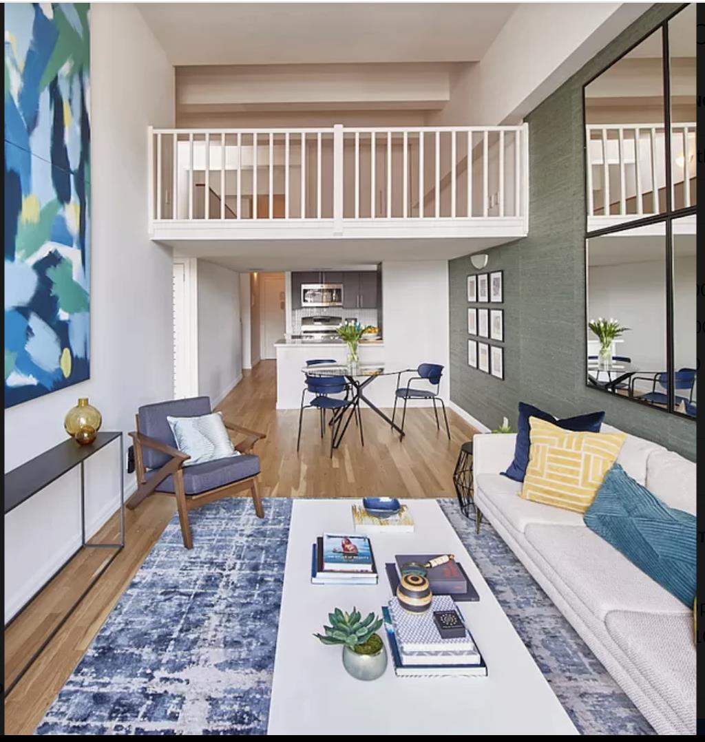 a living room with furniture a rug and a window