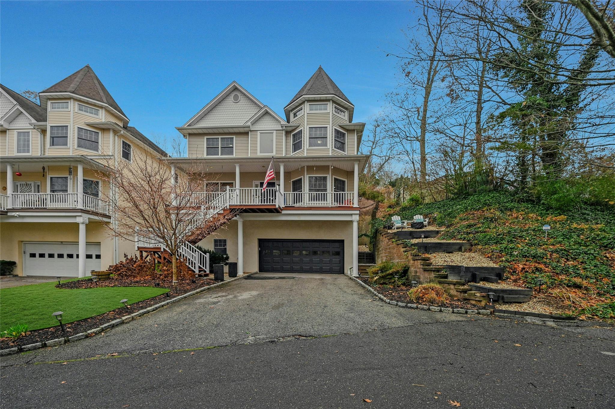 Victorian house featuring covered porch and a garage