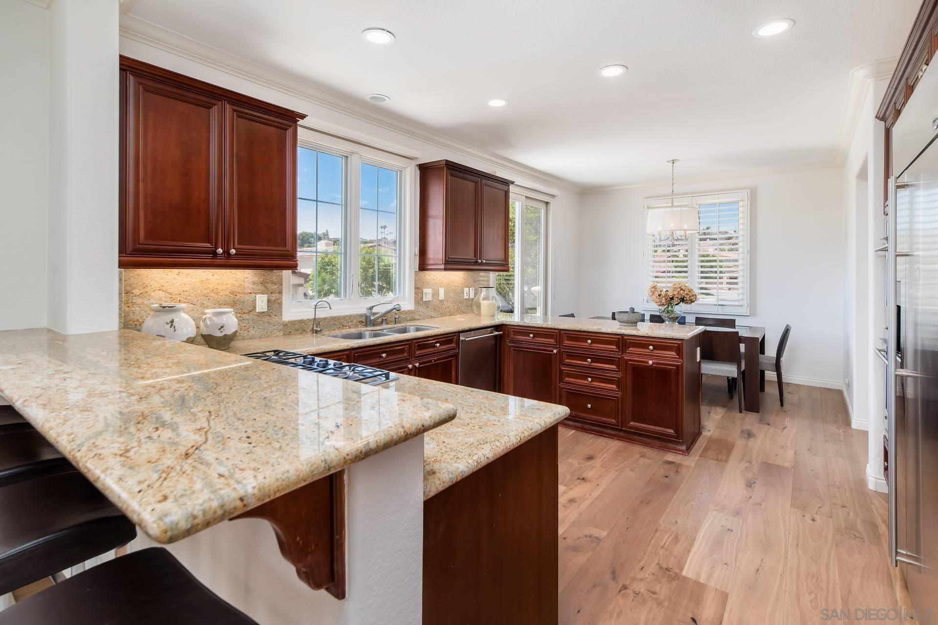 a kitchen with a sink a counter top space and living room