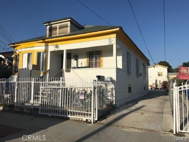 a view of a house with wooden fence