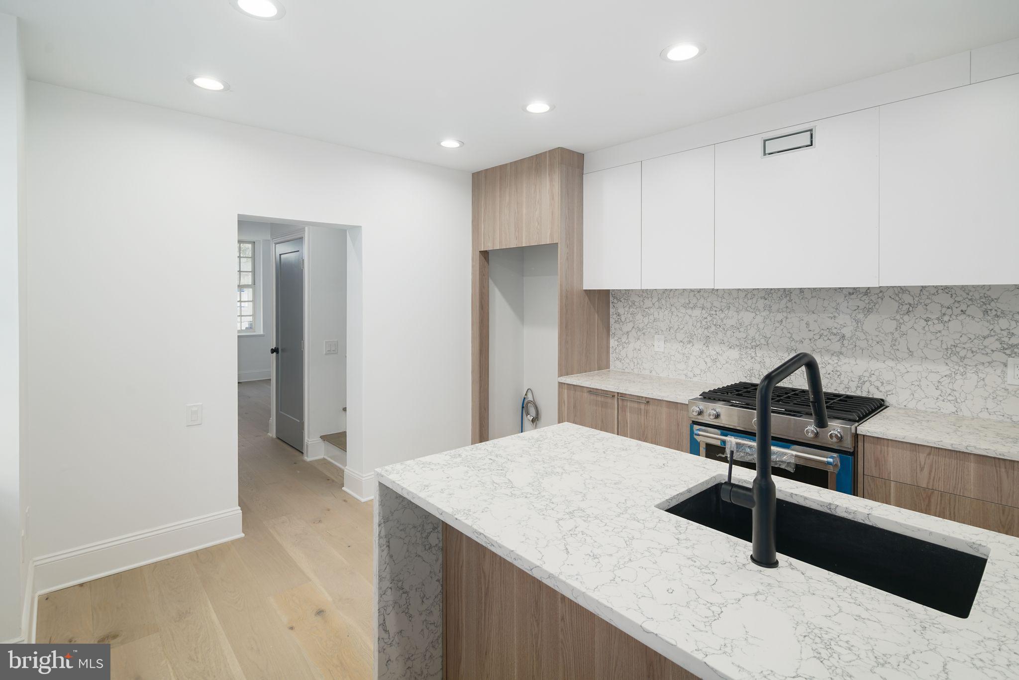 a kitchen with a table and chairs