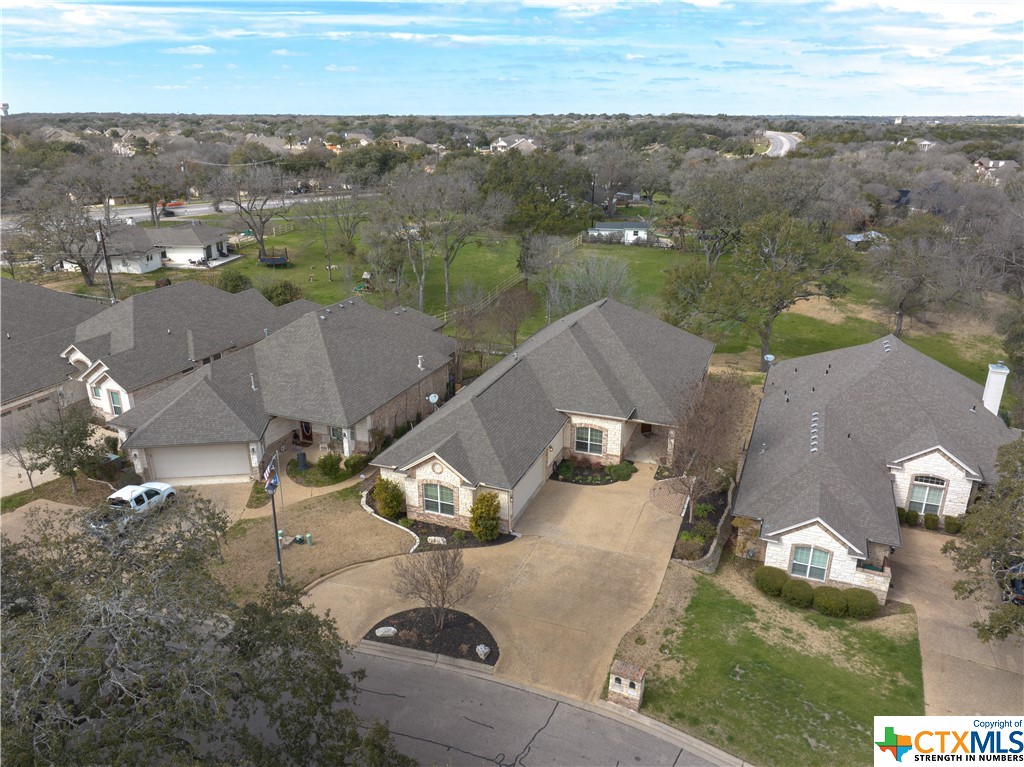 an aerial view of residential houses with outdoor space and river