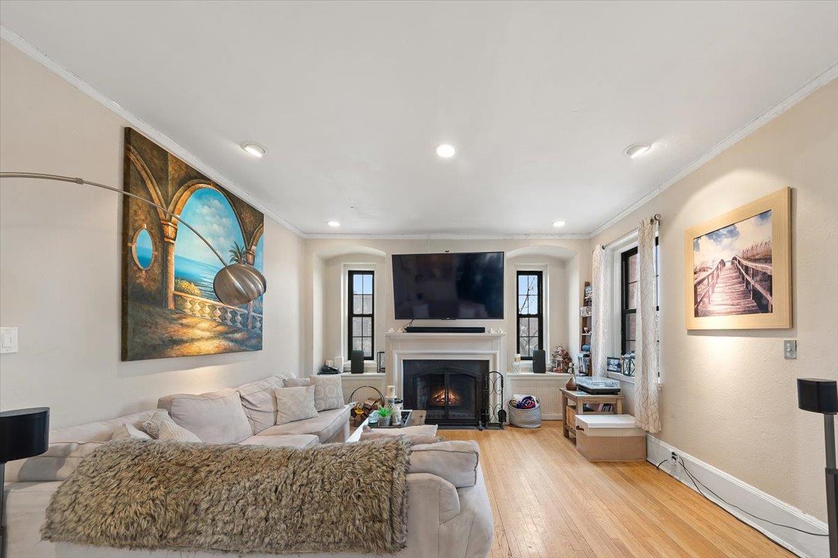 Formal Living Room with W/B Fireplace, Built-in's, Recessed Lighting, Multiple Exposures, and 9' Ceilings