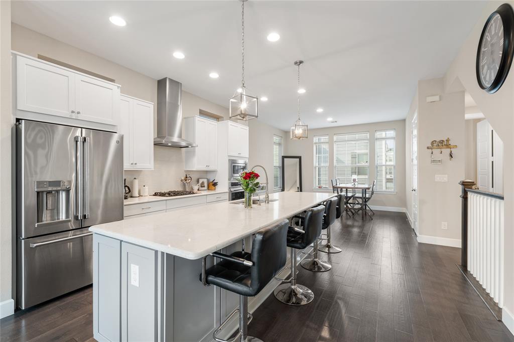 a kitchen with counter top space a sink appliances and cabinets