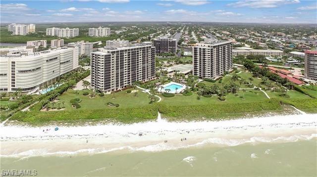 Aerial view featuring a water view and a view of the beach