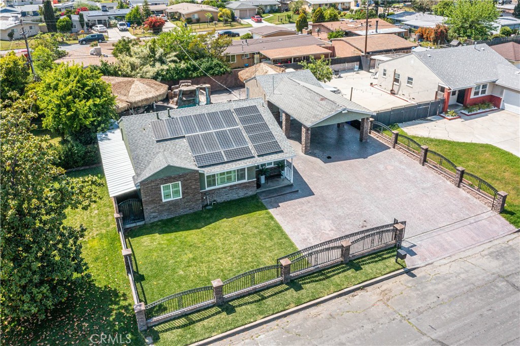 an aerial view of a house with swimming pool and outdoor seating