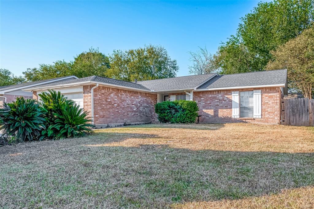 This charming one-story brick house boasts classic elegance.