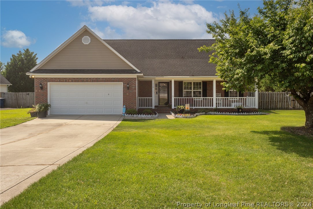 a front view of house with yard and outdoor seating