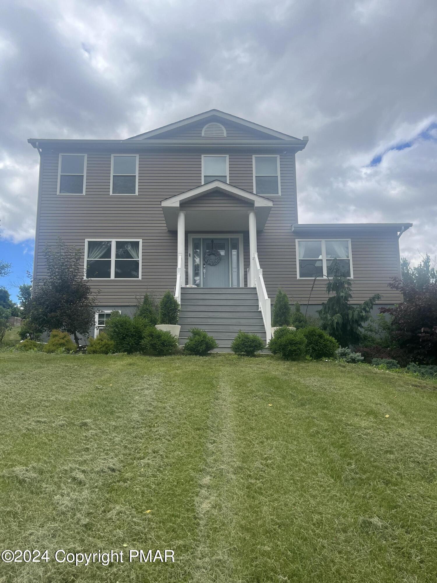 a front view of a house with garden