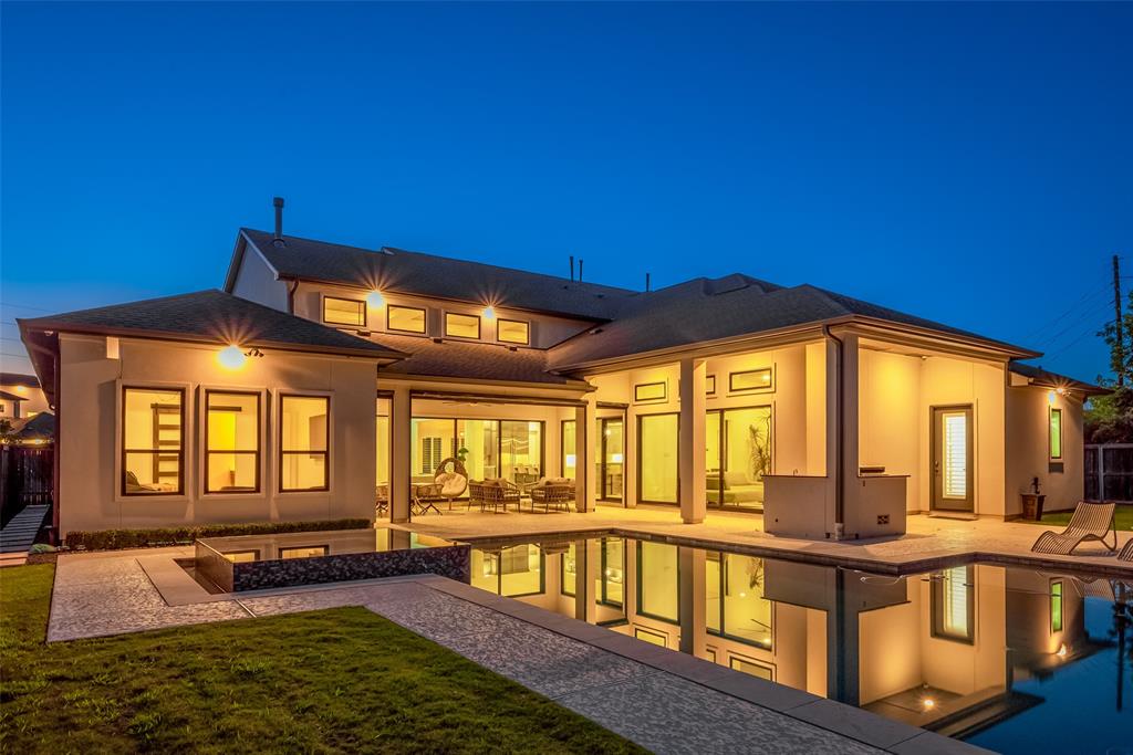 a view of an house with swimming pool in front of it