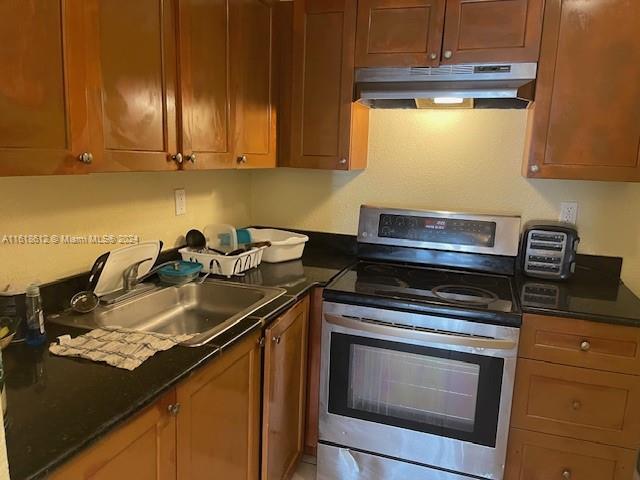 a kitchen with sink cabinets and appliances