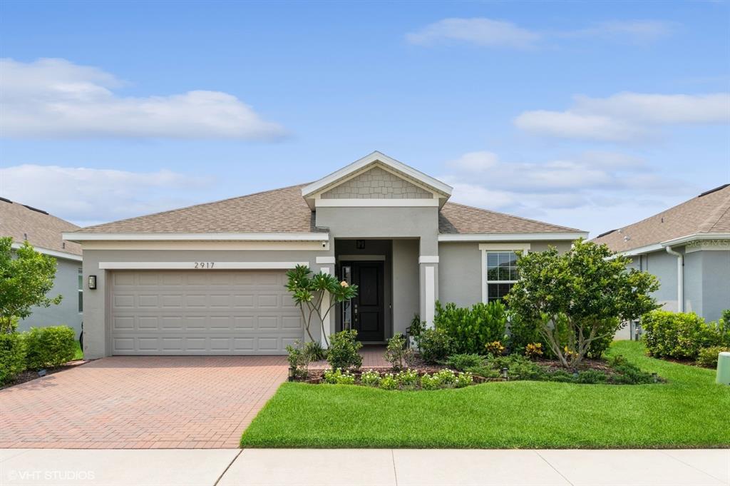 a front view of a house with a yard and garage