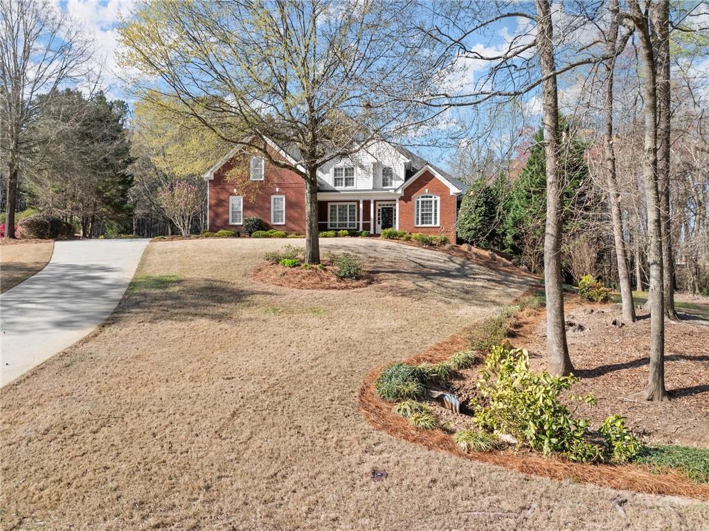 a front view of a house with a yard covered in snow