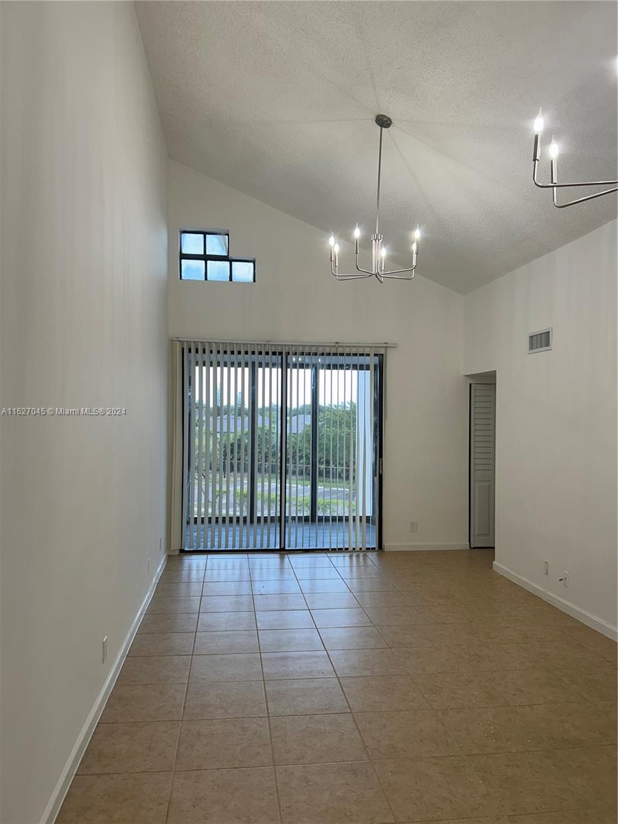 a view of an empty room with glass door