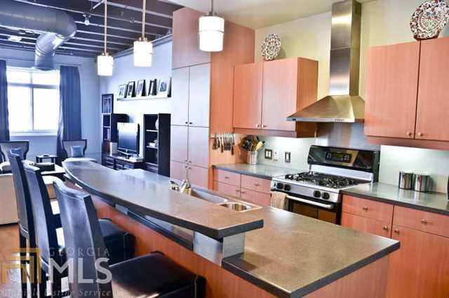 a kitchen with stainless steel appliances a stove a sink dishwasher and cabinets