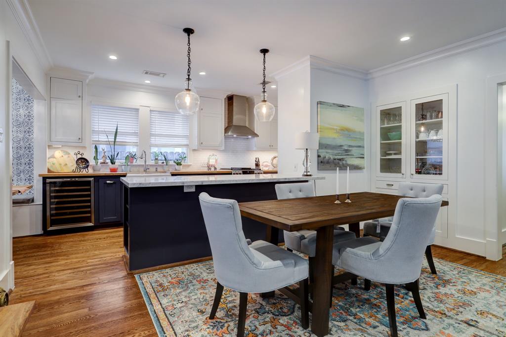 a dining table with chairs and kitchen view