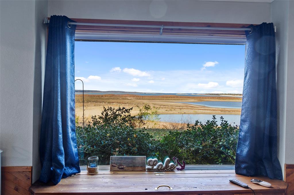 a view of a balcony with floor to ceiling windows with wooden floor