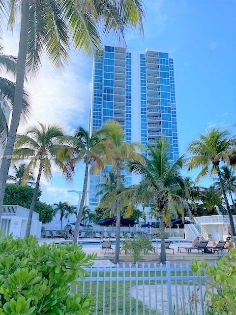 a palm tree sitting in front of a building with a palm trees