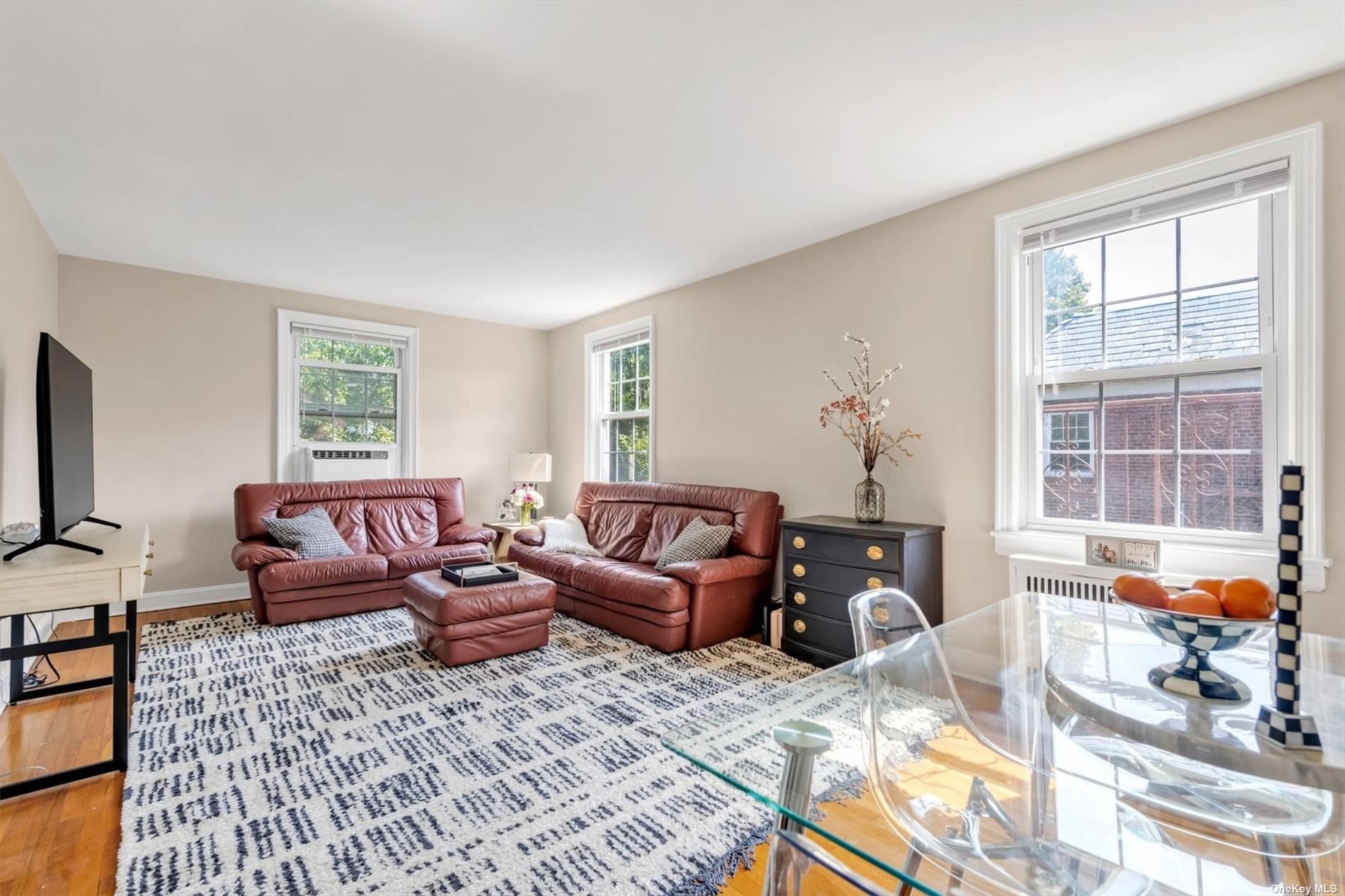 a living room with furniture large window and flat screen tv