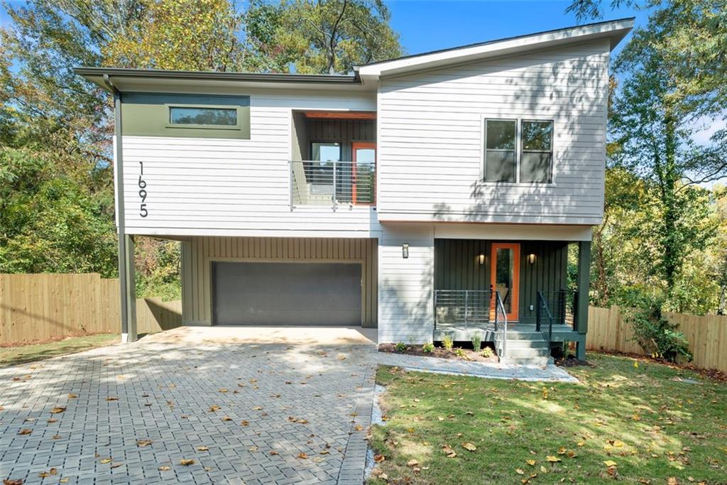 a view of a house with backyard porch and sitting area