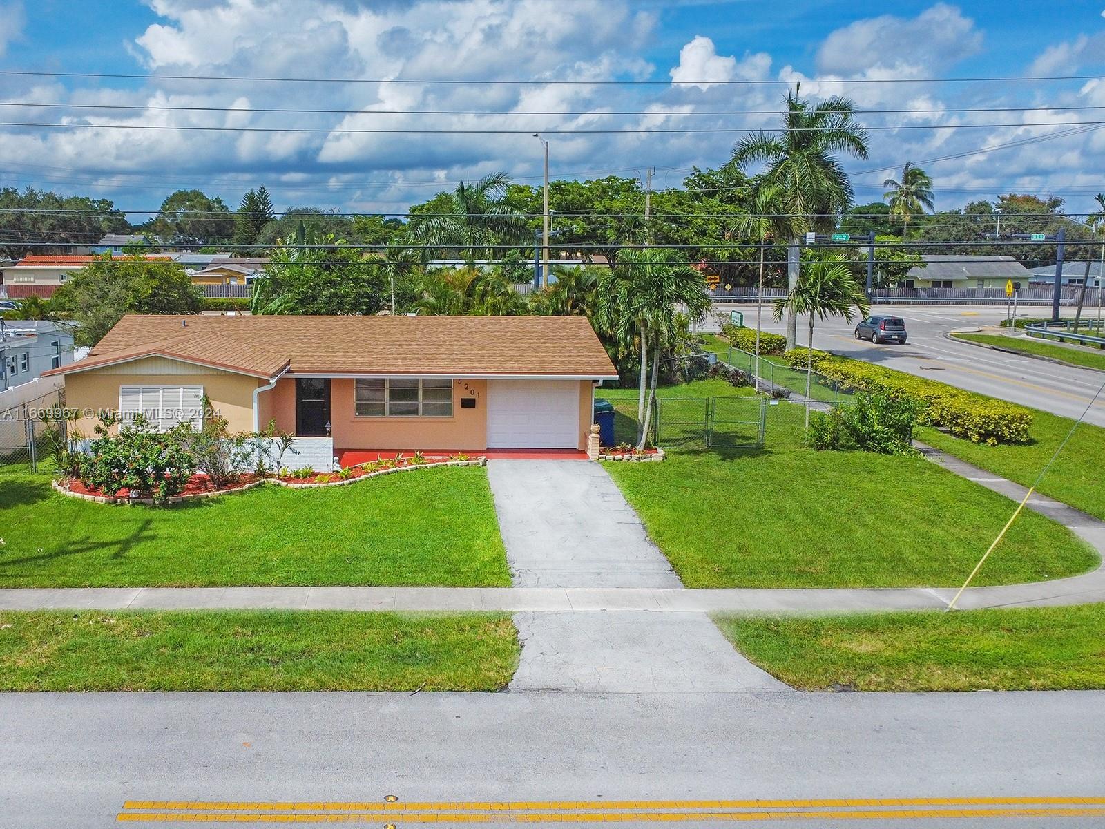 a aerial view of a house with a yard and plants