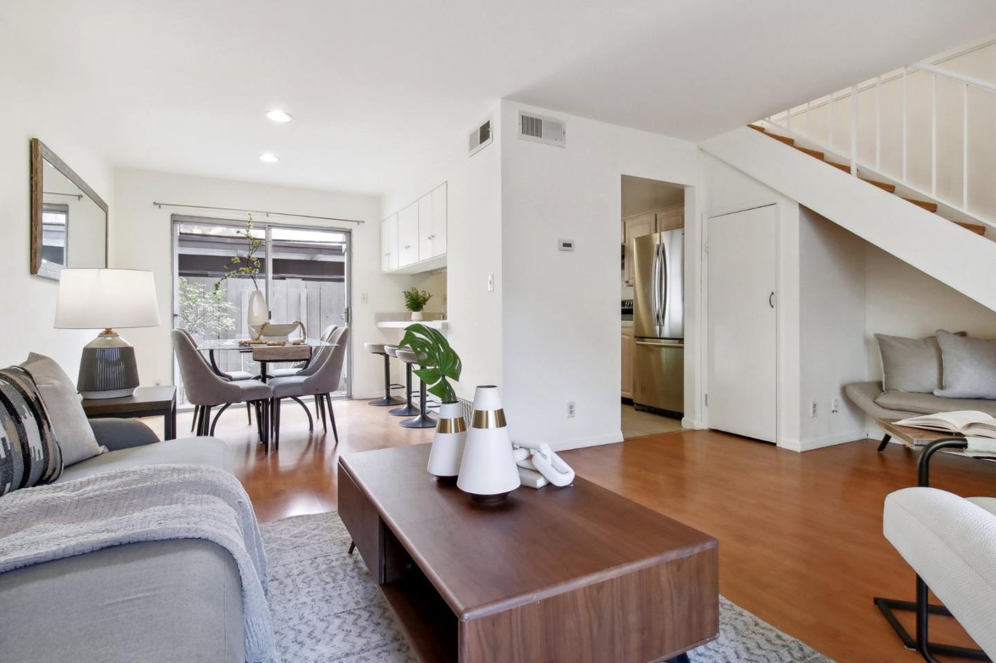 a living room with furniture and wooden floor