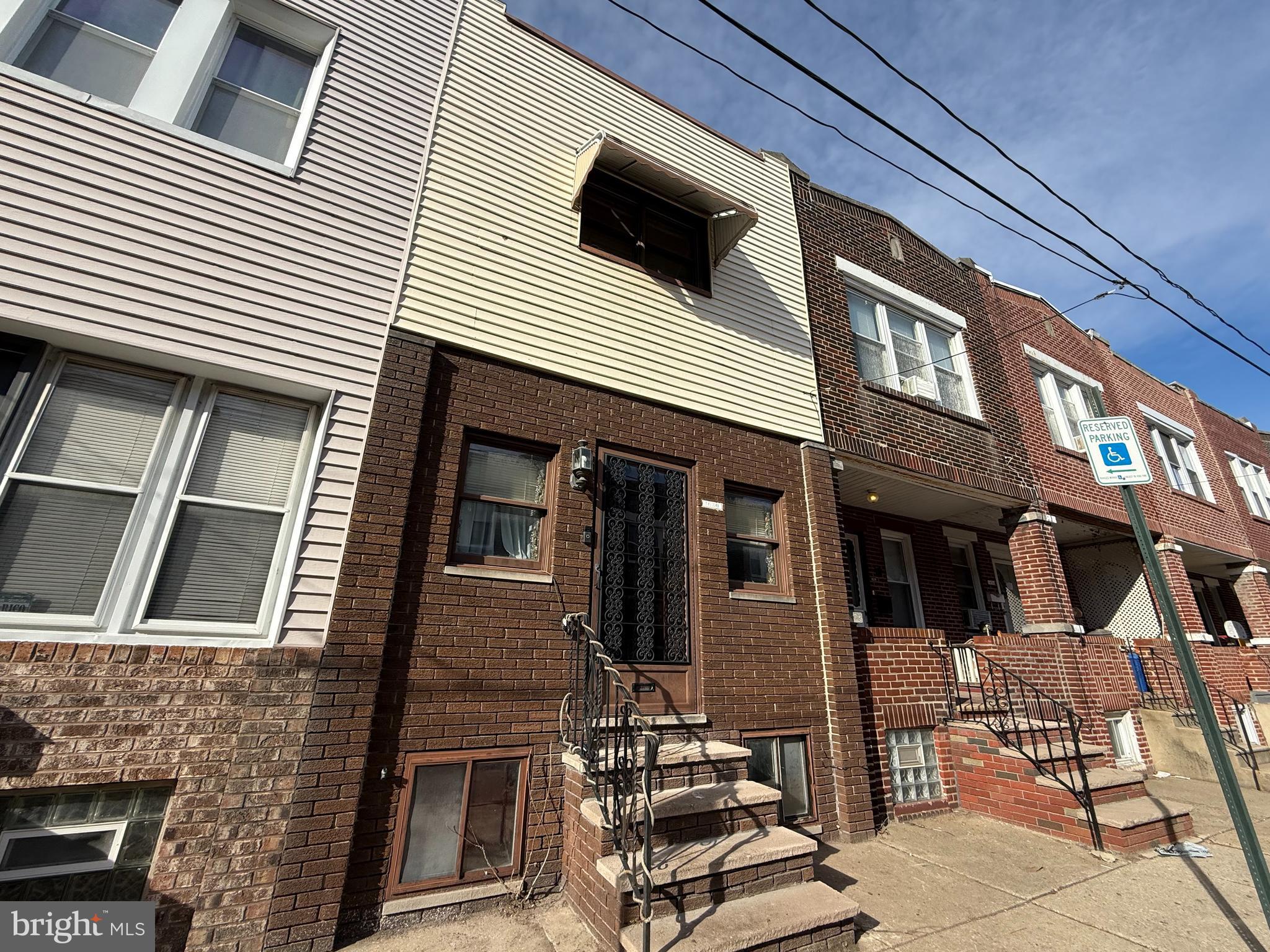 a view of a house with more windows and brick walls