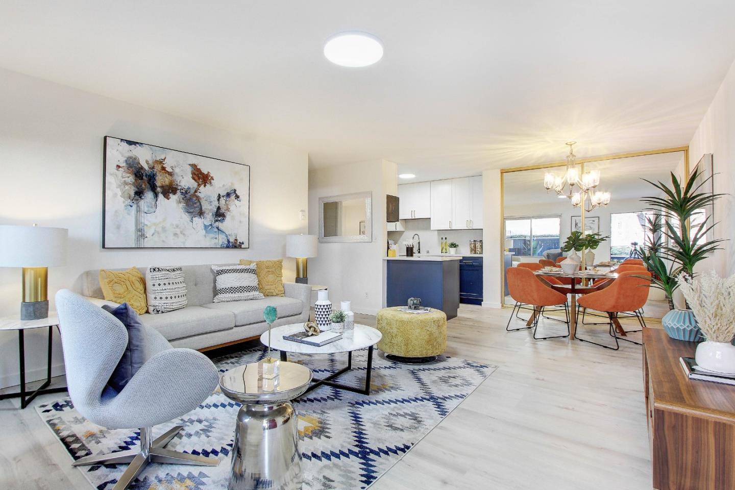 a living room with furniture and a painting on the wall