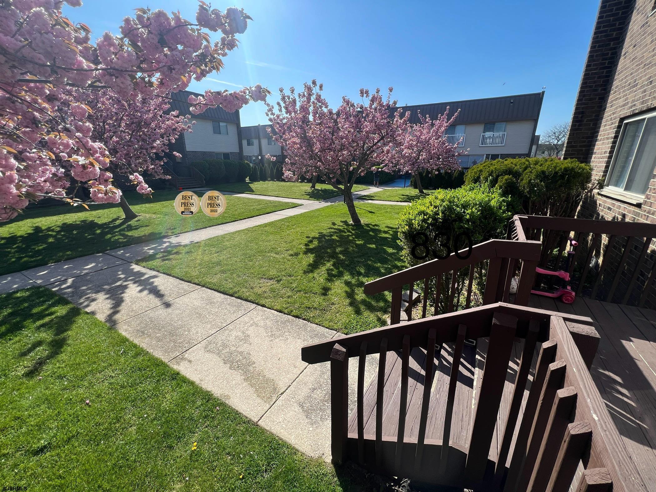 a view of a wooden deck and a yard