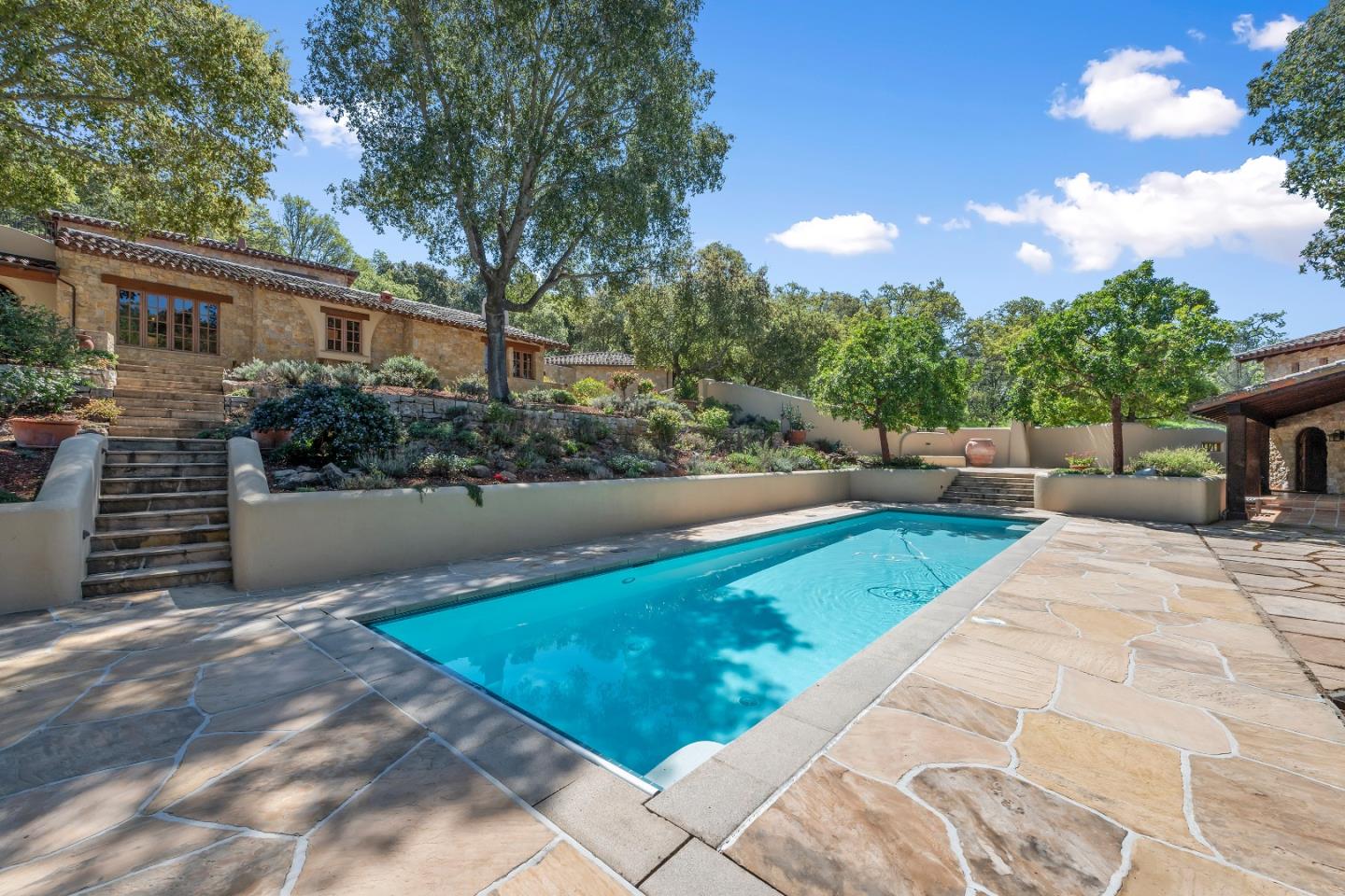 a view of house with yard and sitting area