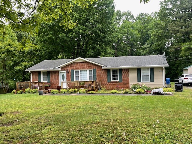 a front view of a house with a garden and trees