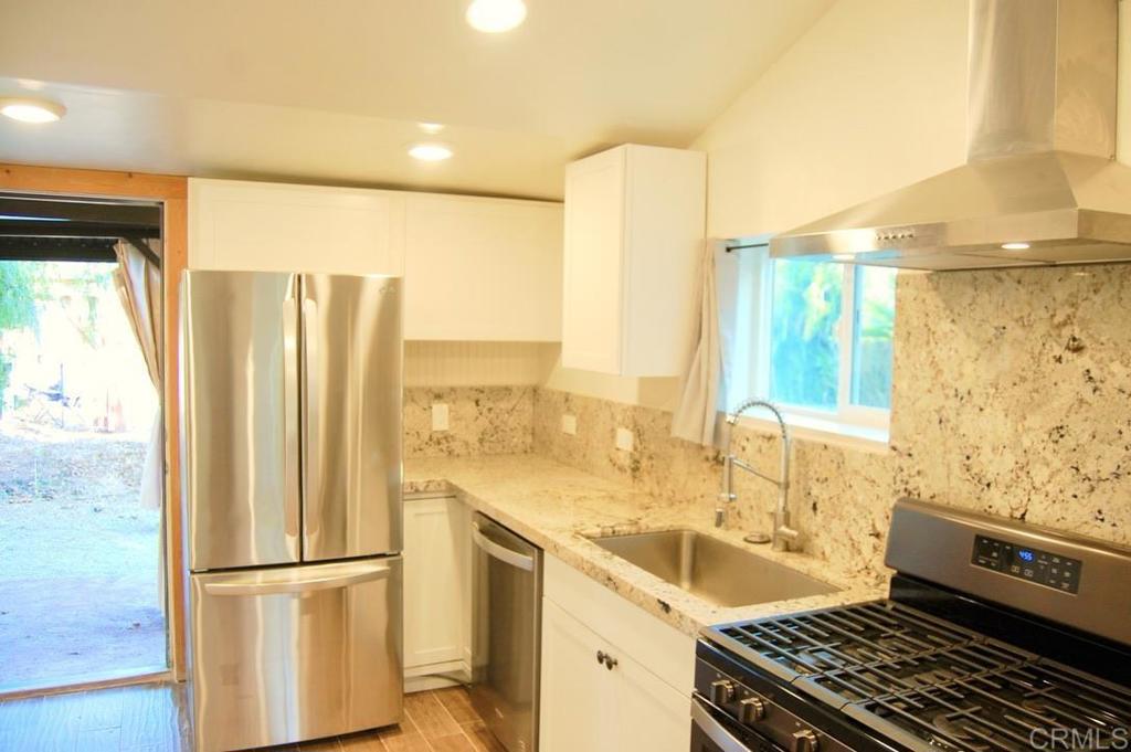 a kitchen with a sink and a refrigerator