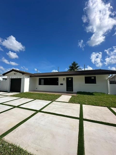 a view of a house with a yard and garage