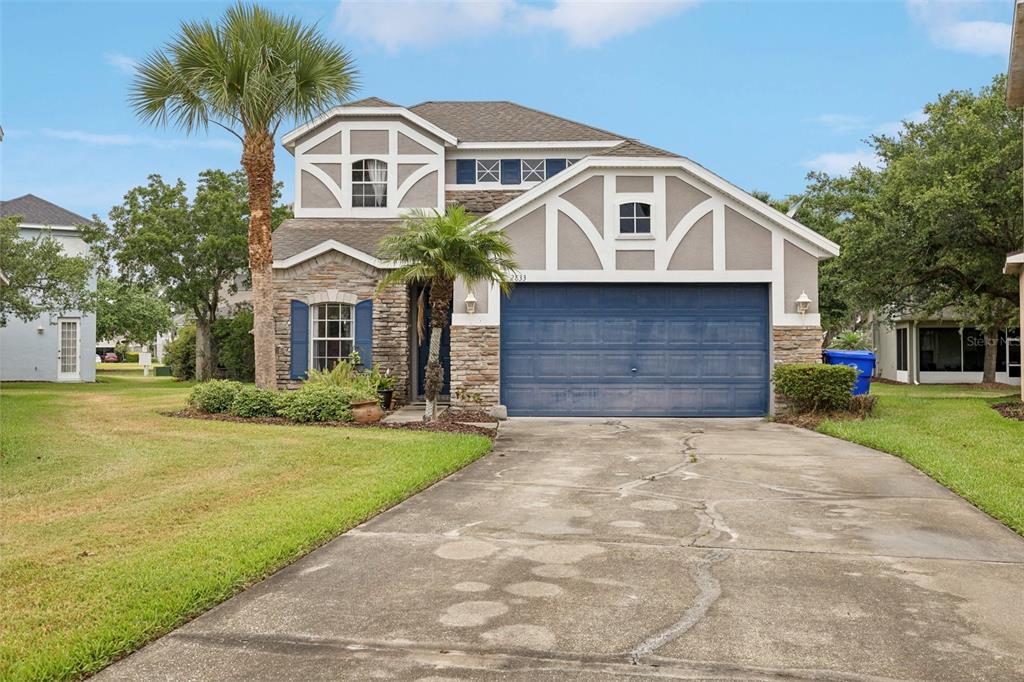 a front view of a house with a yard and garage