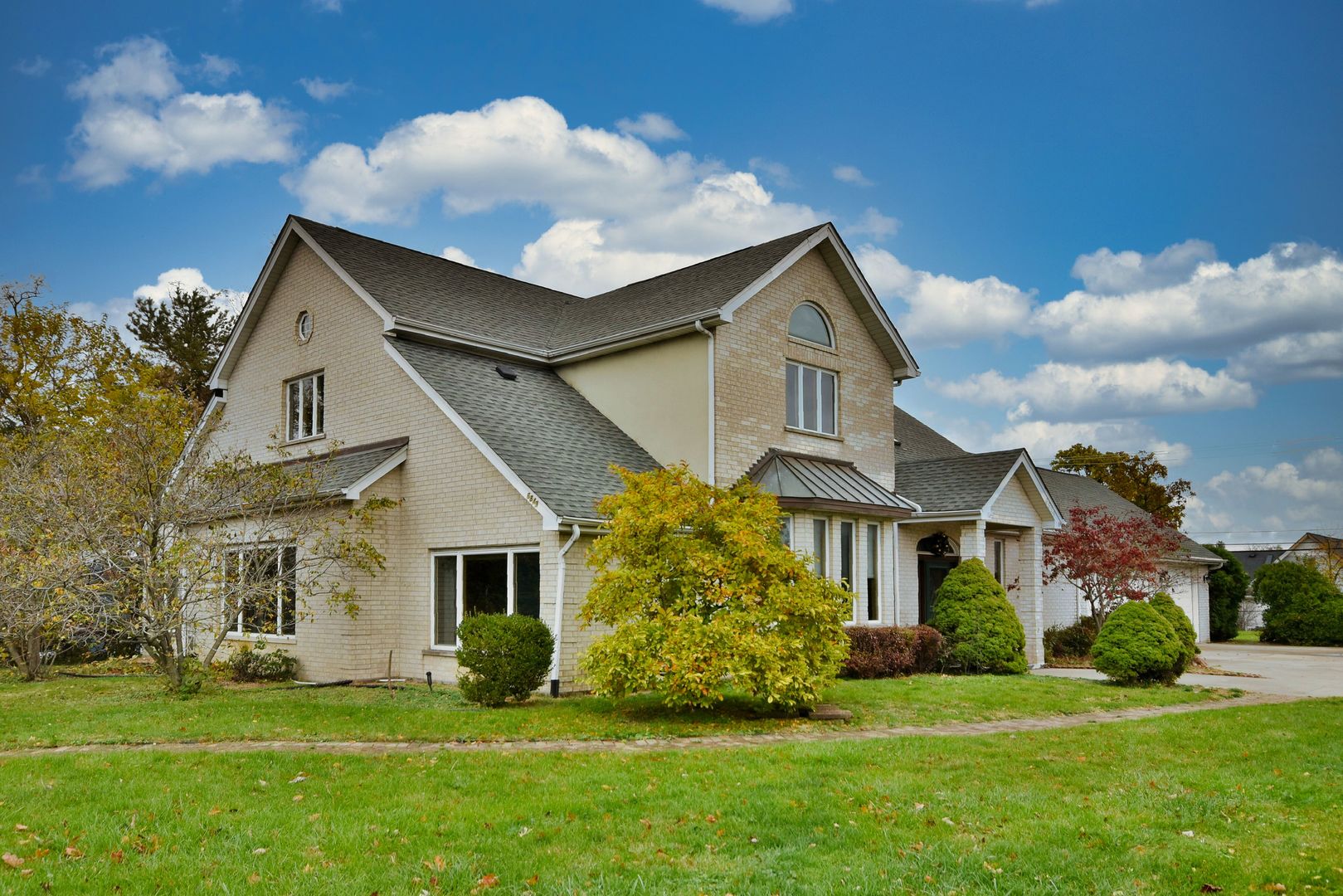 a front view of house with yard and green space