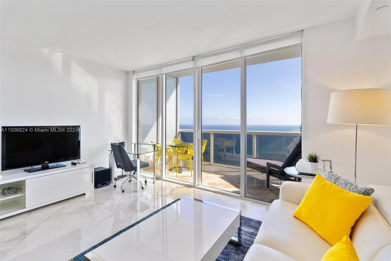 a living room with a flat screen tv and a floor to ceiling window