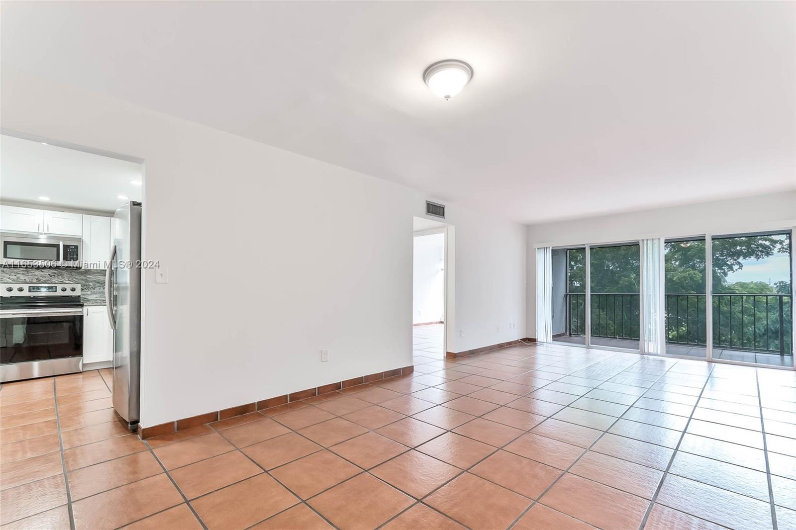 a view of a livingroom with an empty space and a fireplace