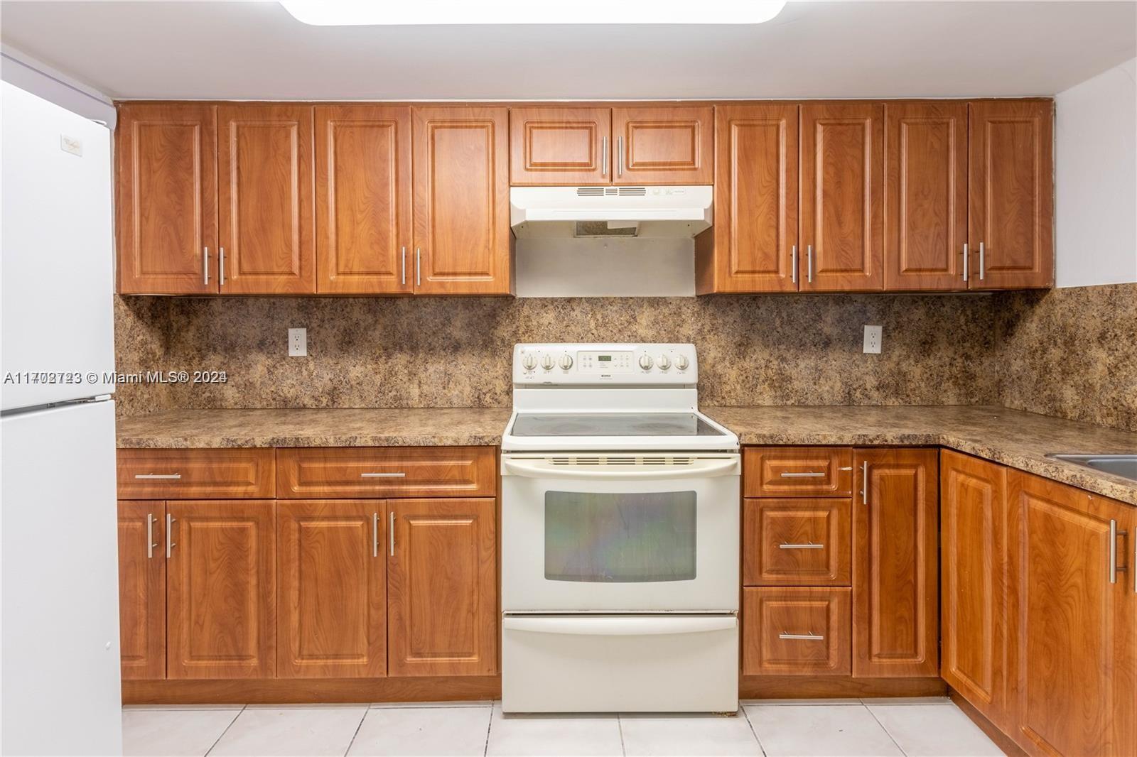 a kitchen with granite countertop cabinets stainless steel appliances and sink