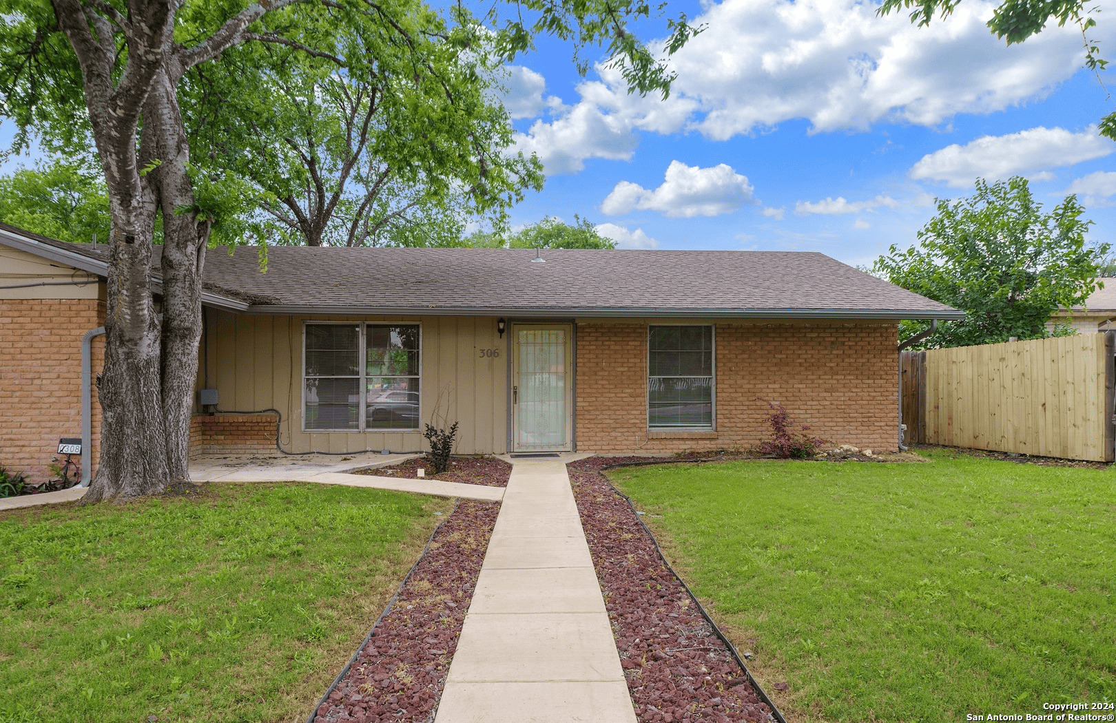 a front view of a house with a garden and patio