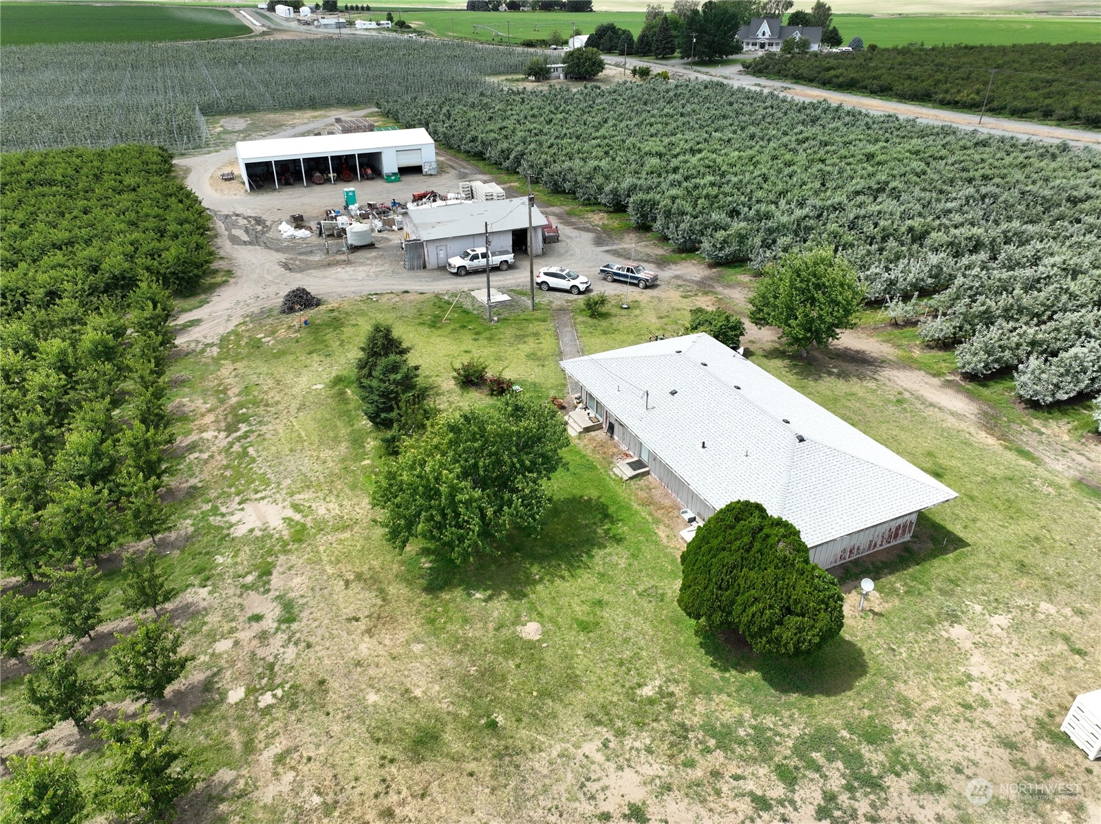 an aerial view of a house with a yard basket ball court and outdoor seating