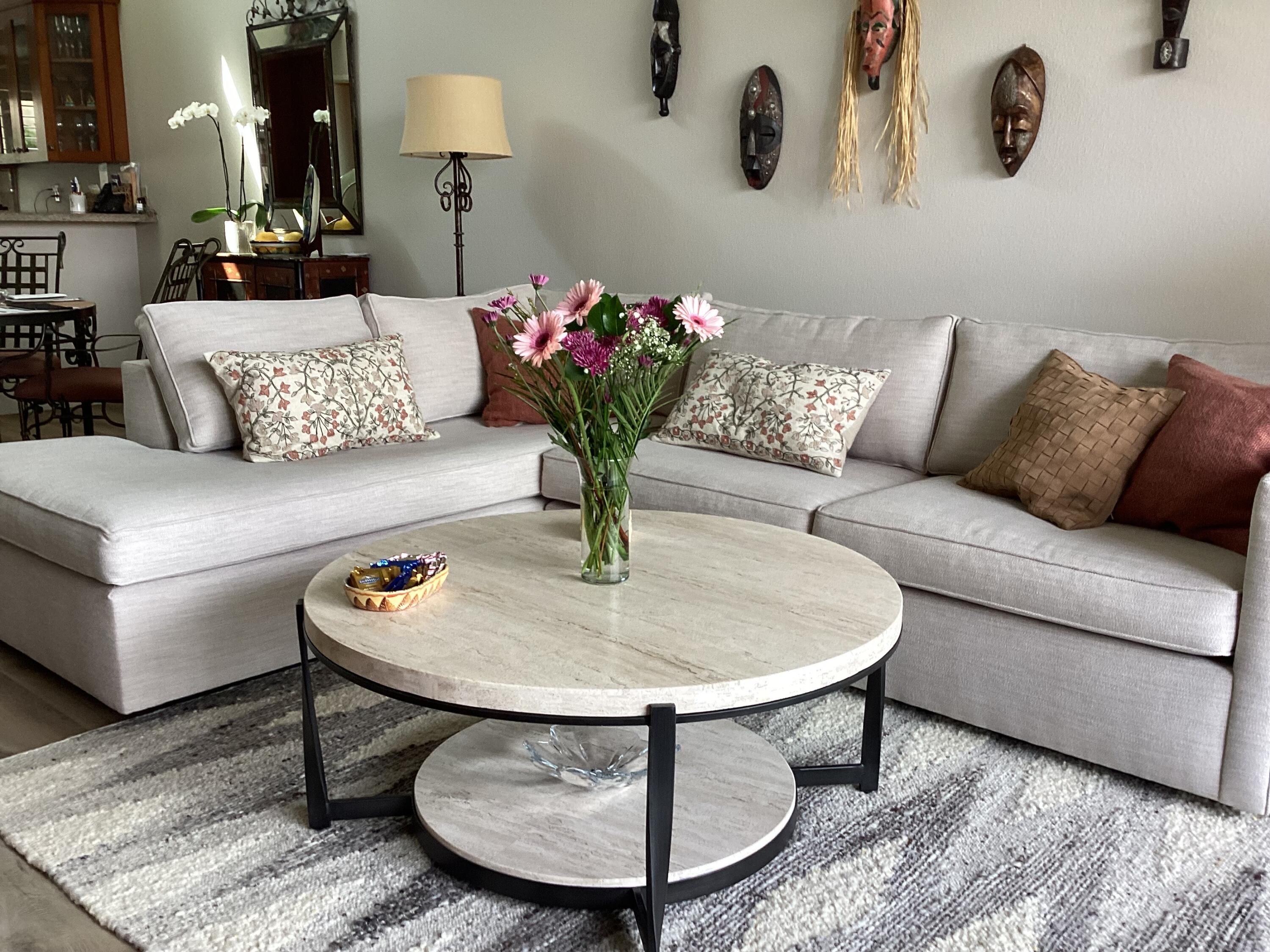 a living room with furniture and flowers