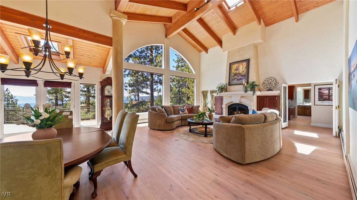 a living room with furniture a fireplace and a floor to ceiling window