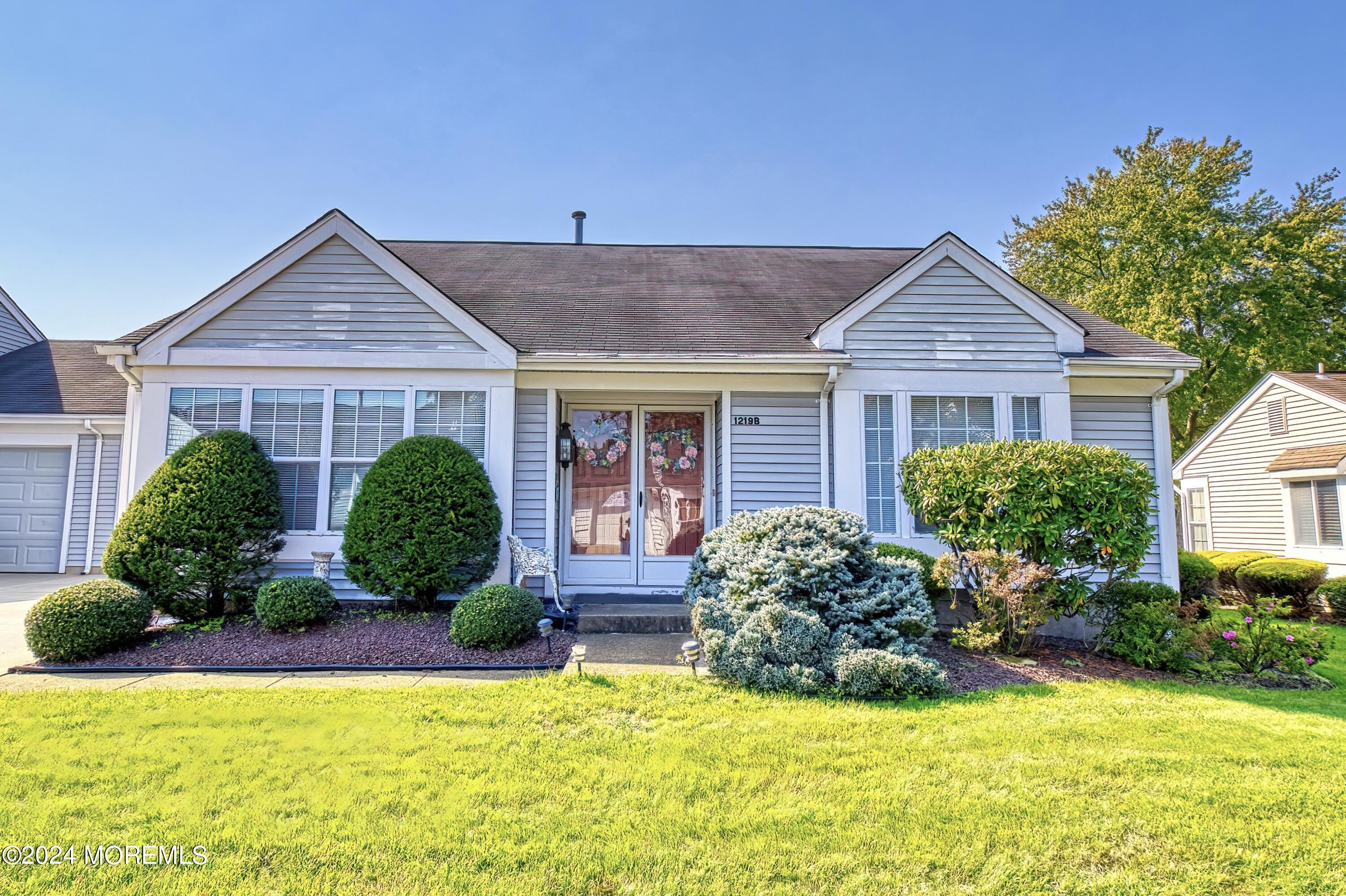 a view of a house with a yard and plants