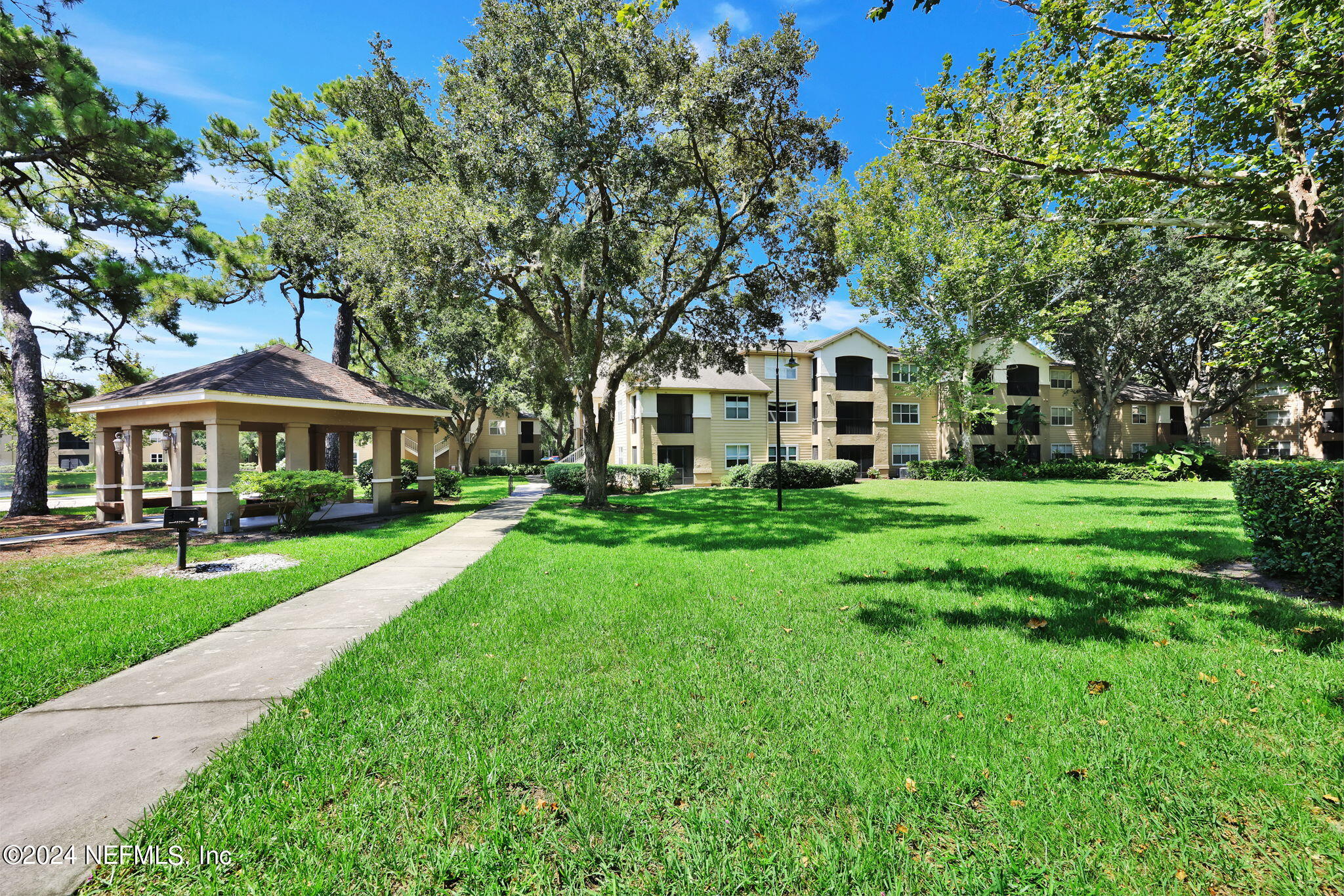 a front view of a house with yard and green space