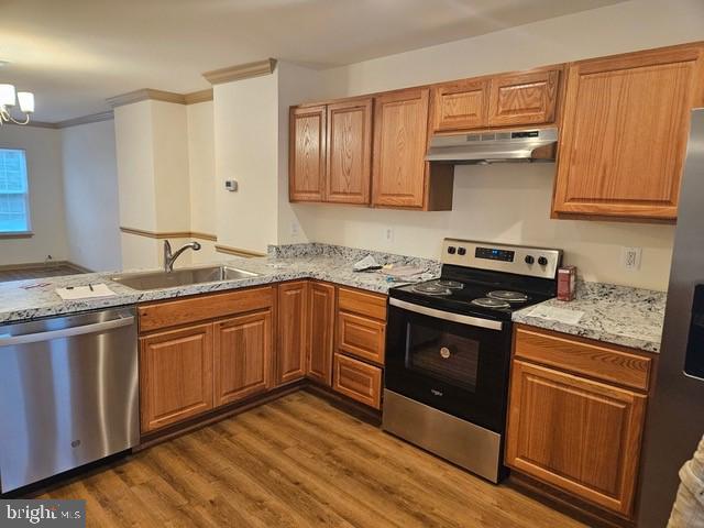 a kitchen with granite countertop stainless steel appliances and wooden cabinets