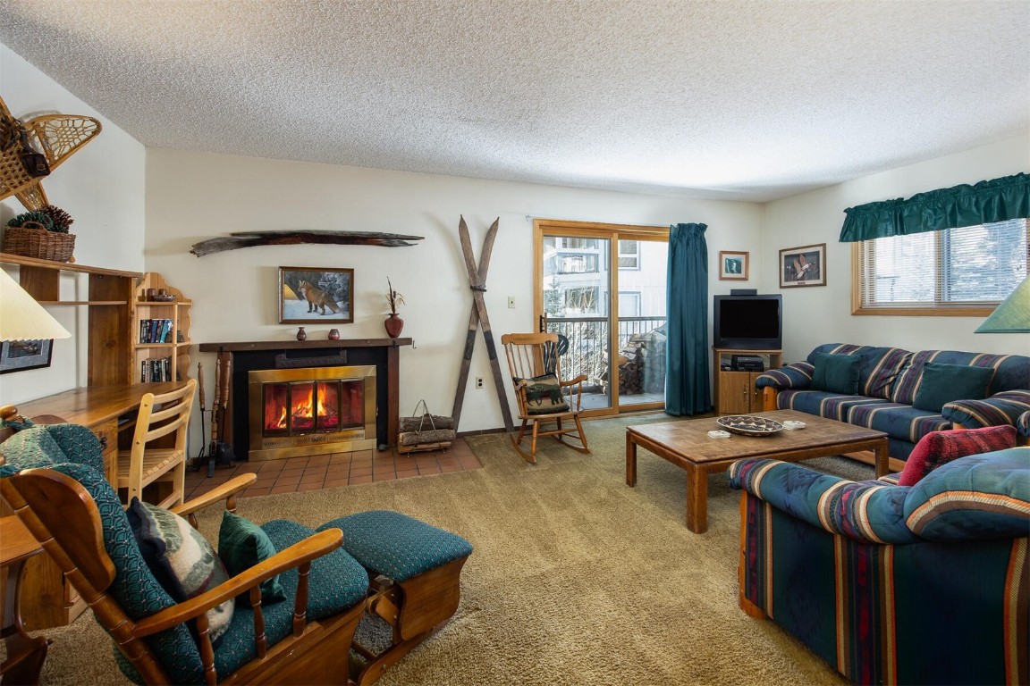 a living room with furniture a flat screen tv and a window