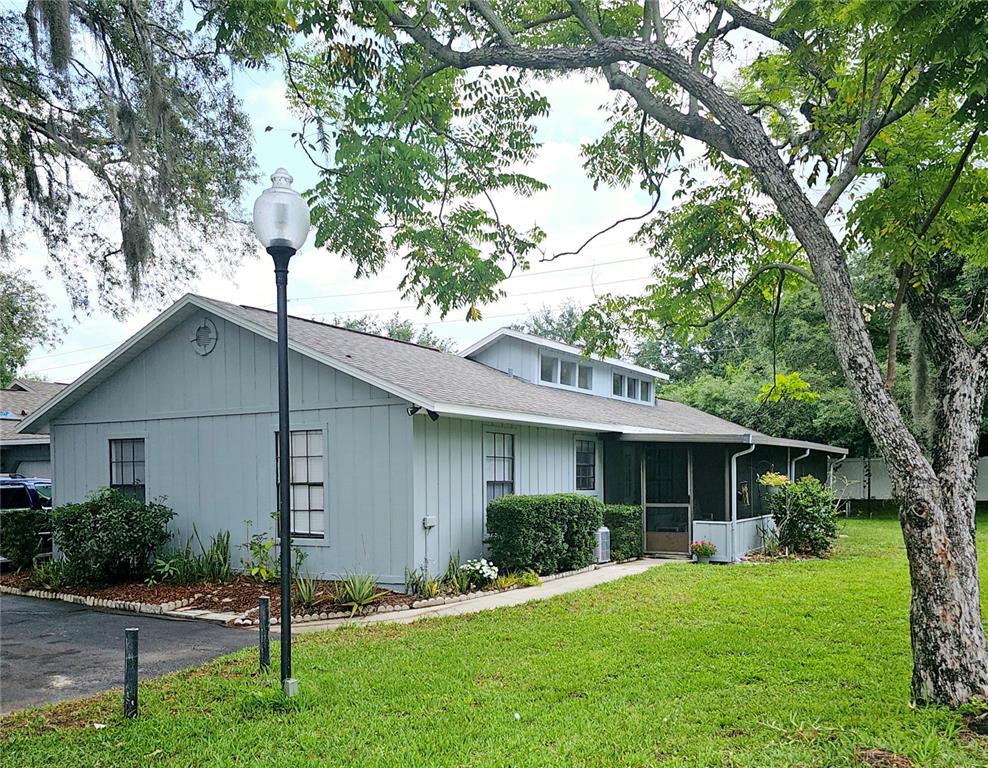 a front view of house with a garden