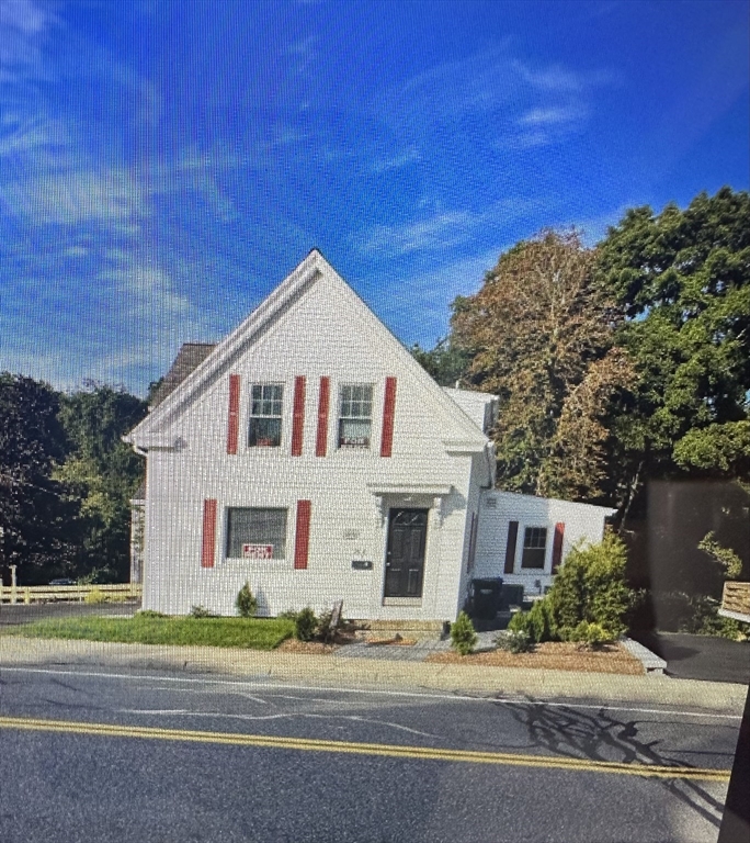 a view of a white house with a yard