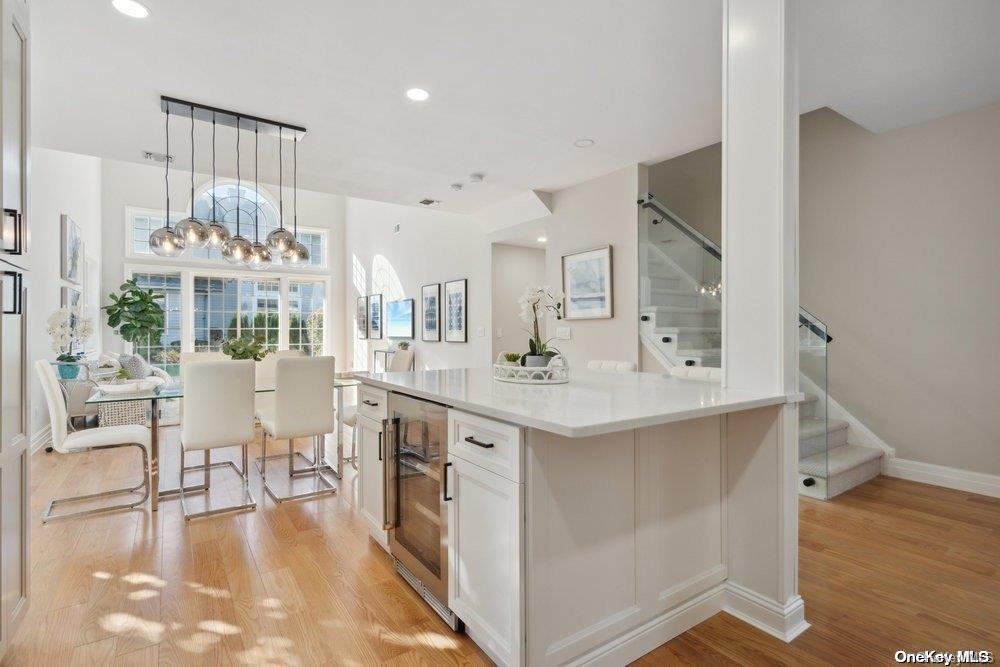 a large white kitchen with lots of counter space and furniture