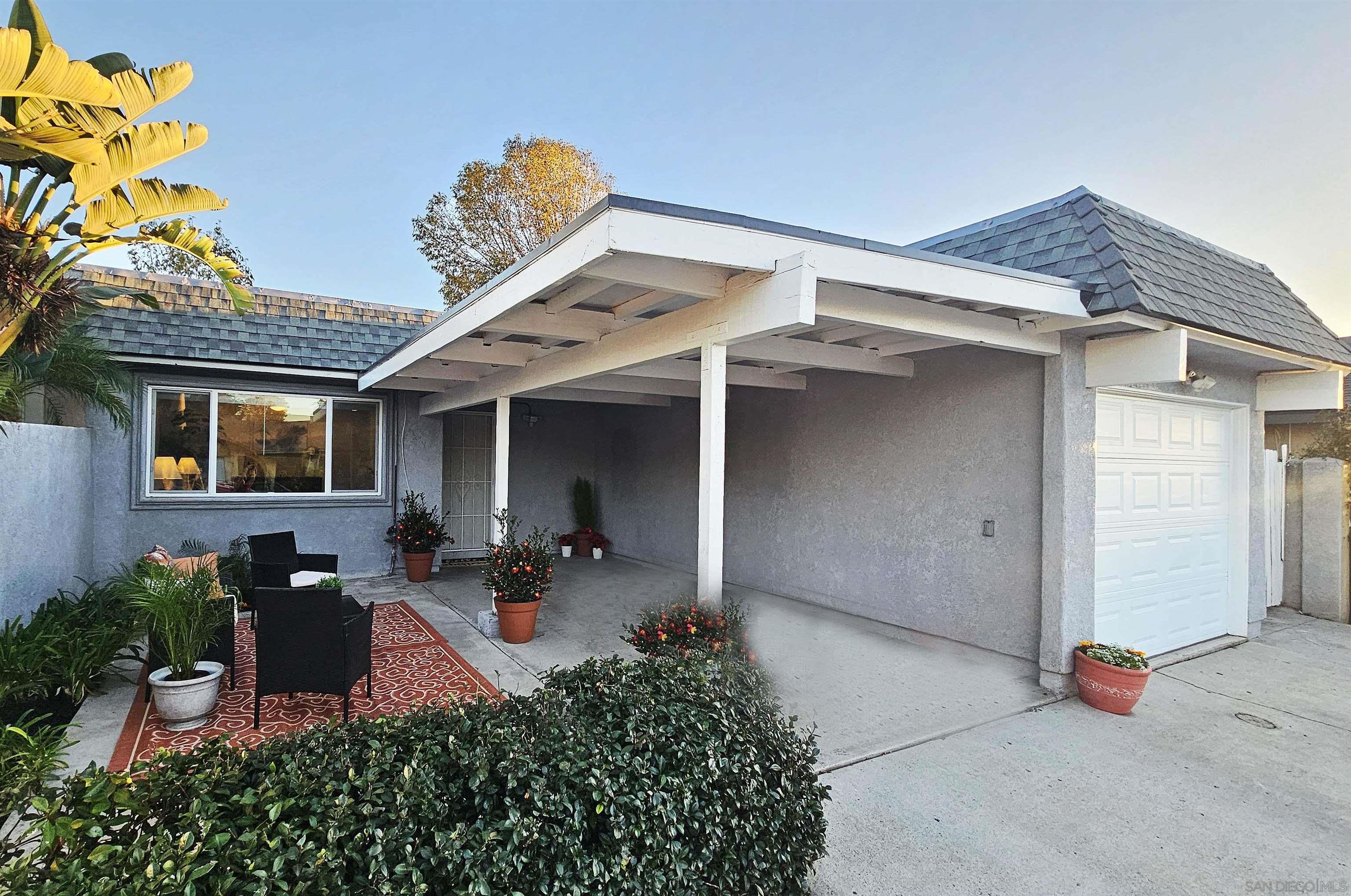 a front view of a house with sitting area